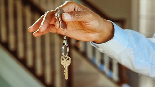 person holding keys to rental unit up